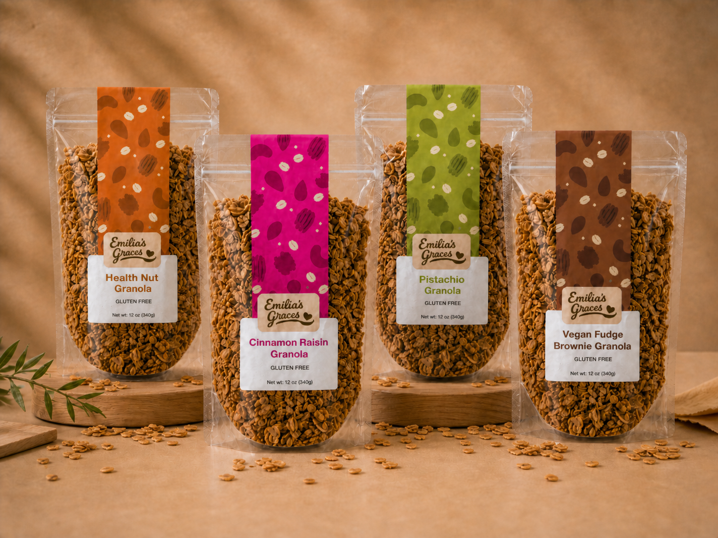 Four Emilia's Graces granola packages featuring Health Nut, Cinnamon Raisin, Pistachio, and Vegan Fudge Brownie flavors
